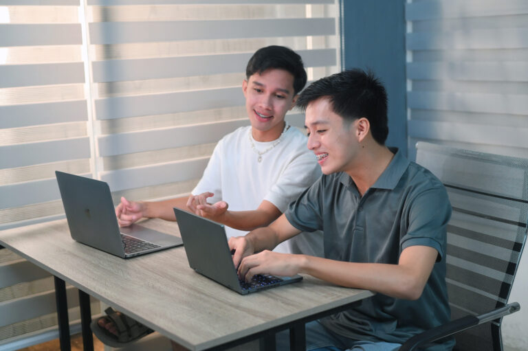 Teens looking at laptop